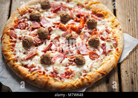Meat feast pizza with ham, bacon, beef Stock Photo