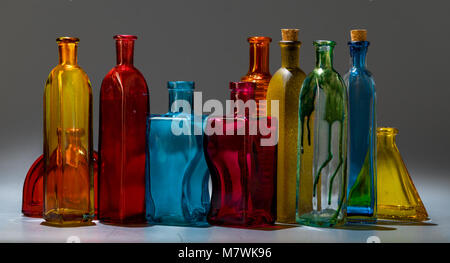 Row of vintage multicolored bottles from glass Stock Photo