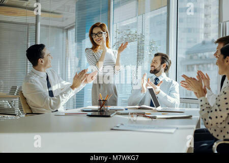 Cheerful colleagues celebrating successful end of project Stock Photo