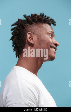 The crazy business Afro-American man standing and wrinkle face blue background. Profile view. Stock Photo