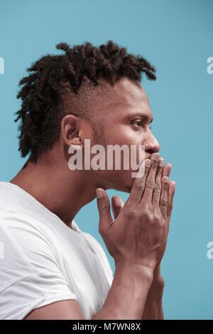 Portrait of attractive Afro-American man with air kiss isolated over blue background Stock Photo