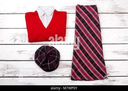 Top view womens winter clothing set on white wooden background. Flat lay fashionable trendy garment. Stock Photo