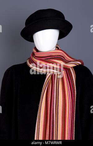 Dark black winter clothing and scarf. Women's apparel on mannequin. Stock Photo