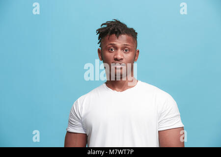 The surprised business Afro-American man standing and looking pink background. Stock Photo