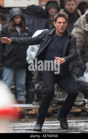 Tom Cruise keeps dry while filming Mission Impossible in London.  In these scenes he can be seen running from an unknown assailant.  Featuring: Tom Cruise Where: London, United Kingdom When: 10 Feb 2018 Credit: WENN.com Stock Photo