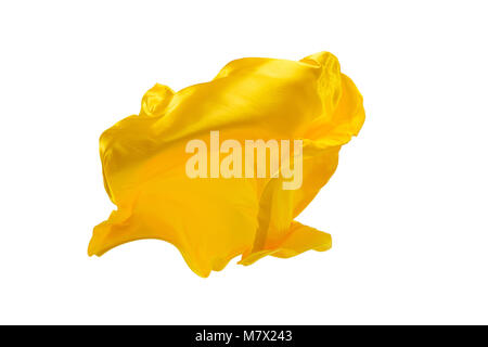 Smooth elegant transparent yellow cloth isolated or separated on white studio background. Texture of flying fabric. Stock Photo