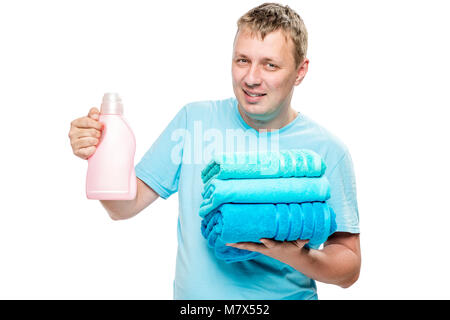 portrait of happy husband with clean towels and gel for washing clothes on white background Stock Photo