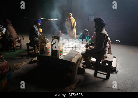 In the kitchen of the Golden temple, women cook, chapati - traditional Indian bread. Stock Photo