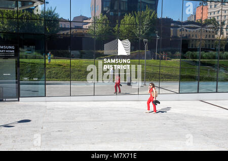 MILAN, ITALY JUNE 7, 2017 - A woman walks outside the Samsung electronic Italia building in the new zone of Porta Nuova in Milan, Italy. Stock Photo