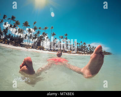 Man enjoying his summer vacation, turquoise water of Caribbean sea and Punta Cana beach. Stock Photo