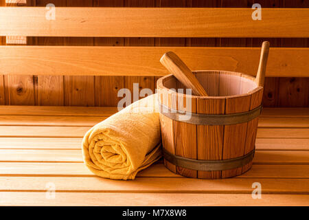 Finnish Wooden Sauna Bucket, Ladle and Towel Stock Photo