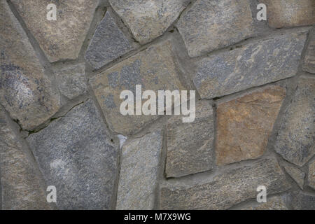 Stone wall texture,white stones in the park. Decorative background of stones, the texture of pebbles in different sizes and colors. Stock Photo