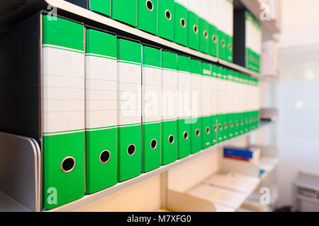 Folders with documents on office shelves. Stock Photo