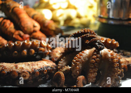 Grilled octopus on the night food market in Forodhani Garden. Stone Town. Zanzaibar. Stock Photo