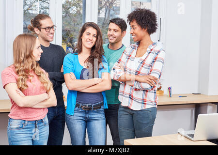 Group students as a self-assured start-up team in the coworking office Stock Photo