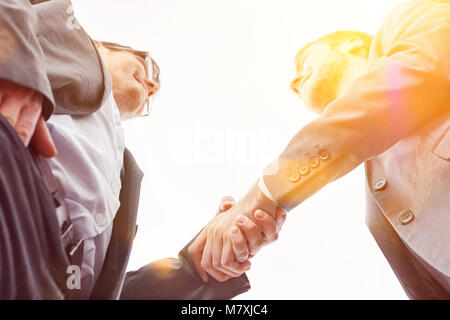 Two businessmen shaking hands in greeting at the office Stock Photo