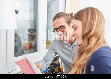 Young female student has help from a friend while studying while studying Stock Photo