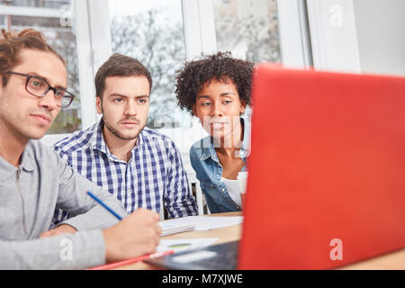 Young start-up team is doing a training on laptop computer in the office Stock Photo
