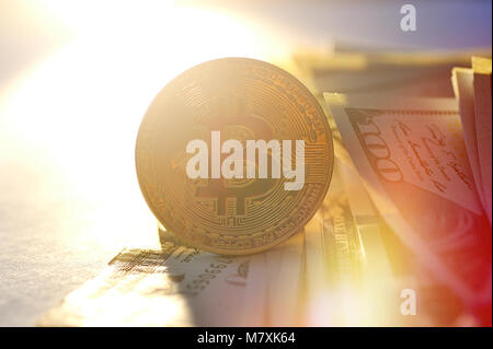 golden bitcoin coin on us dollars close up, Financial concept. Stock Photo