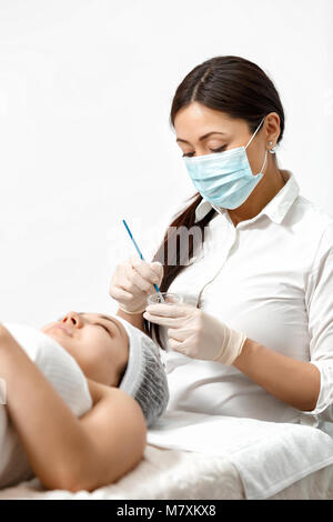 The cosmetologist prepares a mask Stock Photo