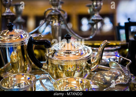 Vintage silver teaset in antiques store. Stock Photo