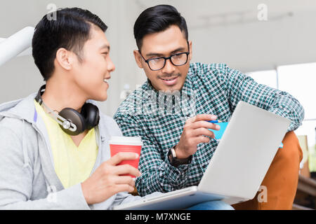 Experienced employee explaining to his colleague business information Stock Photo