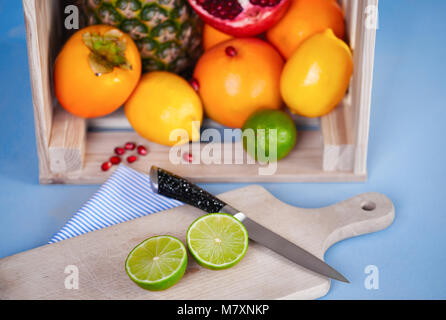 Fruits with chopping block and knife on the table Stock Photo