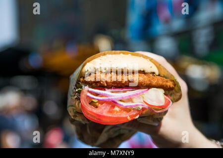 Vegan deep fried Seitan burger with tomatoes and onions Stock Photo