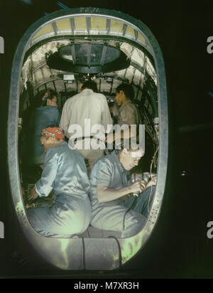 Group of Men and Women Working inside Fuselage of Liberator Bomber, Consolidated Aircraft Corp., Fort Worth, Texas, USA, Howard R. Hollem for Office of War Information, October 1942 Stock Photo