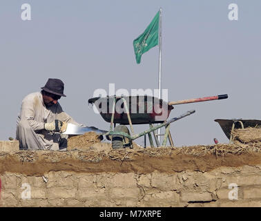 worker, refurbishing an old palace made of adobe and earth in Diriyya / Diriyah, the home of the Al Saud dynasty in Saudi Arabia. Stock Photo