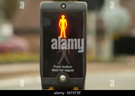 close up of control box for traffic lights at pedestrian crossing with glowing red man indicating to stop Stock Photo
