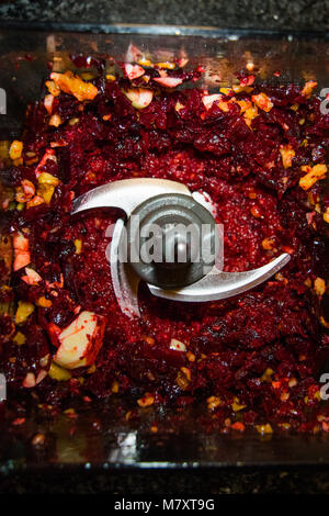 Beet pesto in a blender with garlic, walnuts, pine nuts, and cheese. Stock Photo