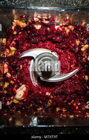 Beet pesto in a blender with garlic, walnuts, pine nuts, and cheese. Stock Photo