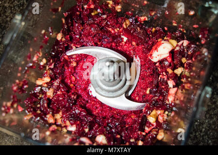 Beet pesto in a blender with garlic, walnuts, pine nuts, and cheese. Stock Photo