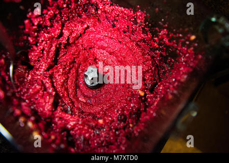 Beet pesto in a blender with garlic, walnuts, pine nuts, and cheese. Stock Photo