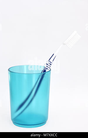 Blue white toothbrush in toothbrush holder (white background) Stock Photo