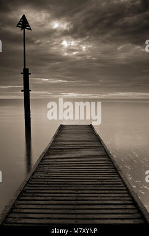 Wooden jetty and post in the sea at Llandudno, North Wales at dawn Stock Photo