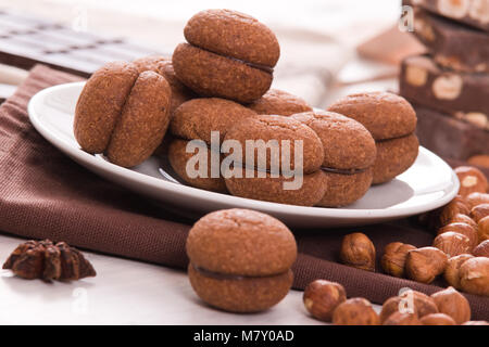 Hazelnut shortbread sandwiches filled with chocolate cream. Stock Photo
