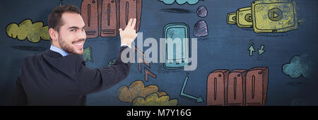 Composite image of smiling businessman pointing these fingers Stock Photo
