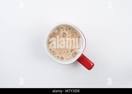 top view of foamy milk coffee or milk tea in a red mug isolated on white background Stock Photo