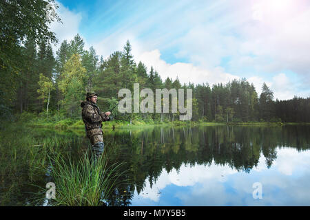 Man fishing on a lake Stock Photo