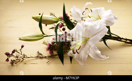Bouquet of freshly cut flowers on yellow surface Stock Photo