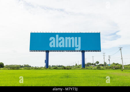 Empty large white advertising billboard in green rice field. for design and advertisement concept Stock Photo