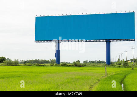 Empty large white advertising billboard in green rice field. for design and advertisement concept Stock Photo