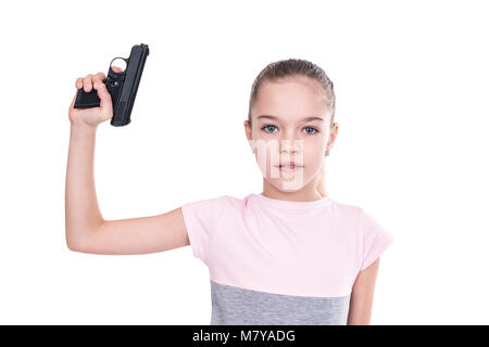Young girl holding a gun in her hand pointing upwards, isolated on a white background Stock Photo