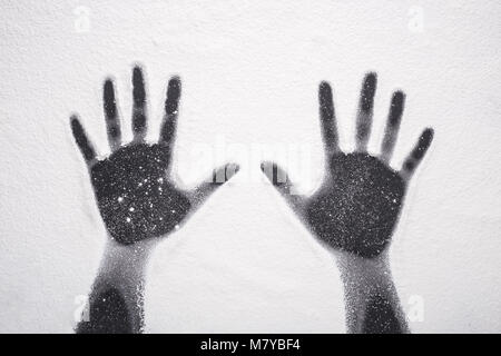 Top view hand prints in flour or white powder on black table background Stock Photo