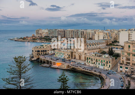 View of Balluta Bay from the 12th floor of Le Méridien Hotel, in Sliema, Malta. The skyline is dominated by the Carmelite Parish Church. Stock Photo