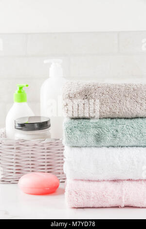 Spa relax and bath concept, sea salt, soap, with cosmetics and towels in bathroom white background, copy space top view Stock Photo