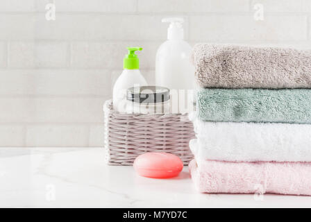 Spa relax and bath concept, sea salt, soap, with cosmetics and towels in bathroom white background, copy space top view Stock Photo