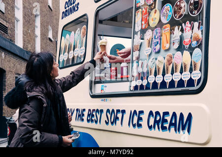 Woman buying ice-cream from Mr. Whippy van in Covent Garden, London. Stock Photo